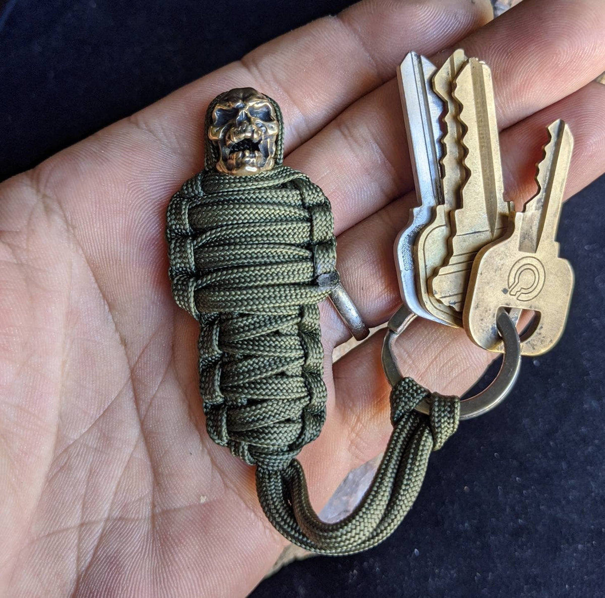 TG olive green paracord keychain with mummy brass skull bead