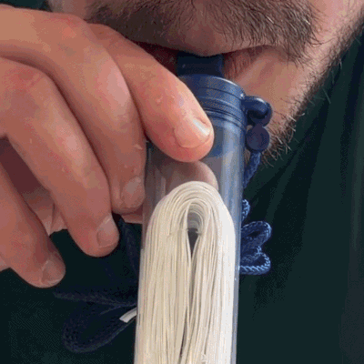 TG Stillwater filter straw being used to drink from a water source